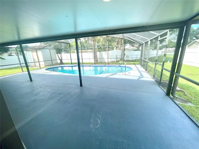 view of swimming pool with a lawn, a patio area, and glass enclosure