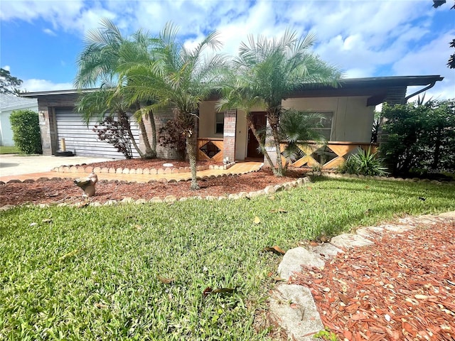 view of front of home featuring a garage and a front lawn