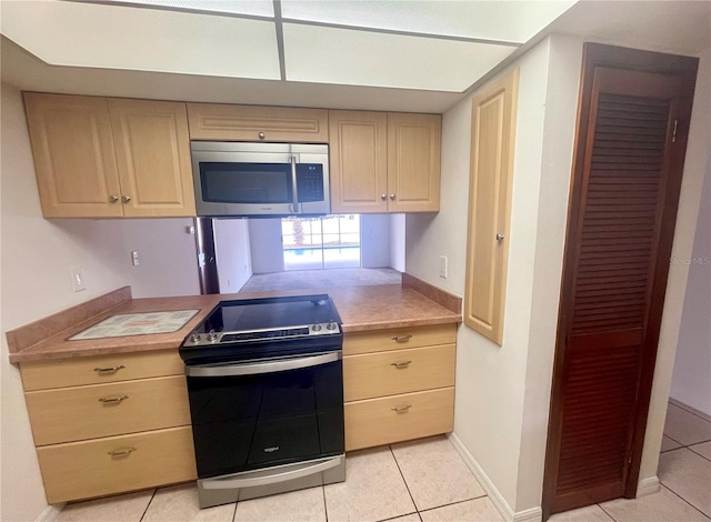 1415 Harnden Rd W, Port Orange, FL 32129 - kitchen with light countertops, appliances with stainless steel finishes, and light tile patterned floors