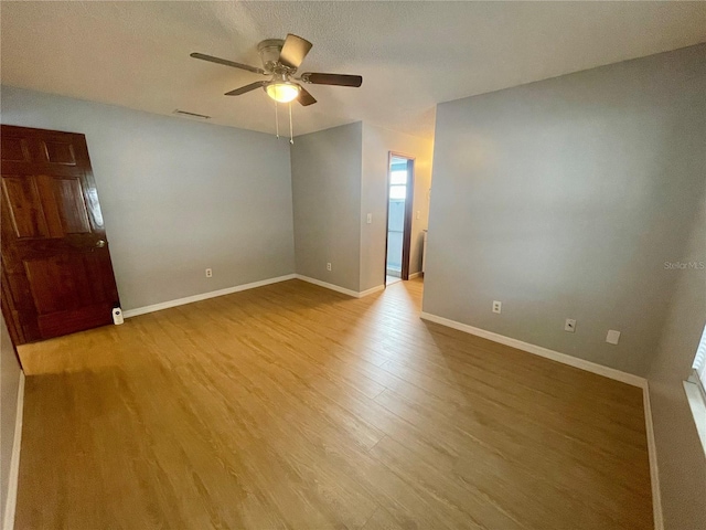 1415 Harnden Rd W, Port Orange, FL 32129 - unfurnished room featuring visible vents, a ceiling fan, baseboards, and wood finished floors