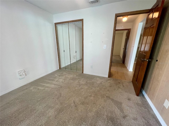 1415 Harnden Rd W, Port Orange, FL 32129 - unfurnished bedroom featuring carpet floors, baseboards, a closet, and visible vents