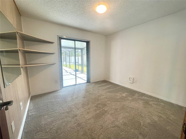 1415 Harnden Rd W, Port Orange, FL 32129 - spare room featuring baseboards, carpet flooring, and a textured ceiling