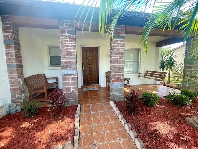 1415 Harnden Rd W, Port Orange, FL 32129 - property entrance featuring a porch and stucco siding