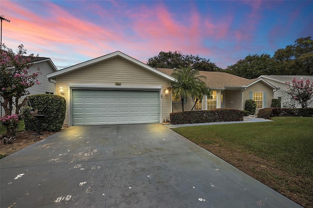 single story home with a lawn and a garage