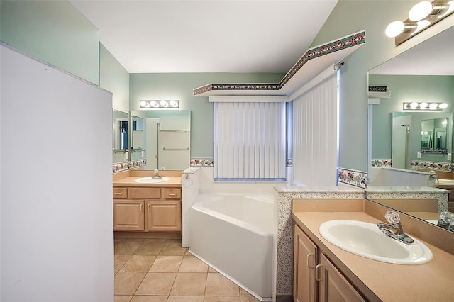 bathroom with vanity, a bathtub, and tile patterned floors