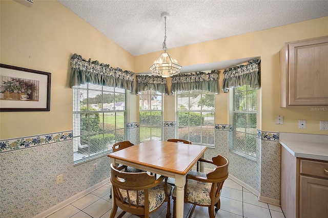 dining space featuring a textured ceiling, light tile patterned floors, tile walls, and a chandelier