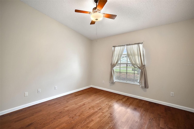 empty room featuring ceiling fan, hardwood / wood-style floors, and a textured ceiling