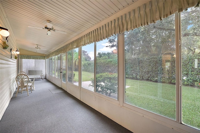 unfurnished sunroom with lofted ceiling and ceiling fan