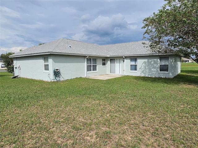 back of house featuring a yard