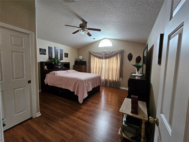 bedroom with ceiling fan, a textured ceiling, dark hardwood / wood-style floors, and vaulted ceiling