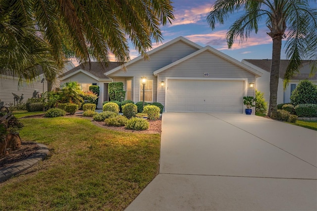 view of front of house featuring a garage and a yard