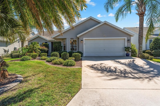 view of front of house with a front yard and a garage