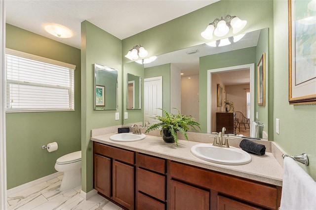 bathroom with toilet and vanity