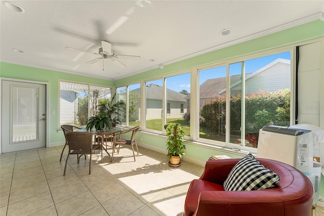 sunroom / solarium featuring ceiling fan