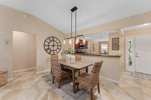 tiled dining space with vaulted ceiling