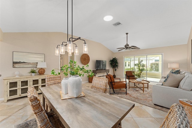 dining area with ceiling fan, vaulted ceiling, and light tile patterned flooring