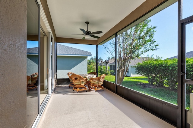 sunroom featuring ceiling fan