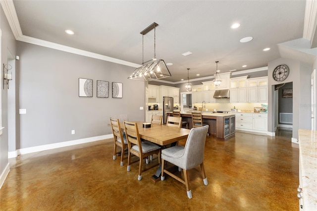 dining space featuring crown molding and sink