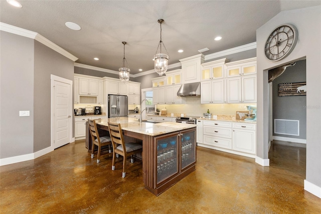 kitchen with hanging light fixtures, a kitchen island with sink, extractor fan, stainless steel appliances, and light stone countertops