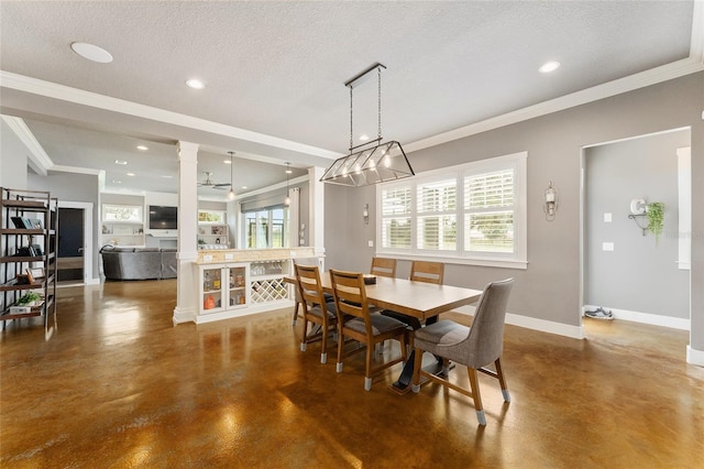 dining space featuring ceiling fan, crown molding, decorative columns, and a textured ceiling