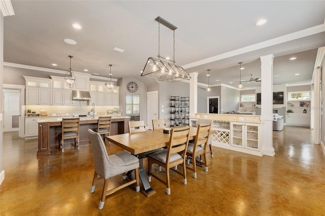 dining area with ornate columns and ornamental molding