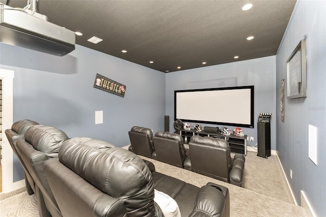 carpeted cinema room with a textured ceiling