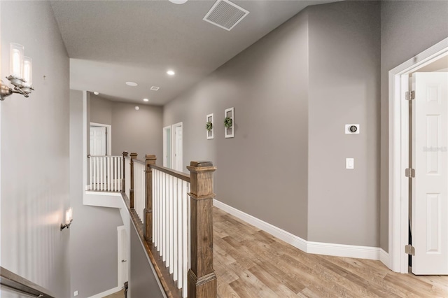 corridor with light hardwood / wood-style flooring