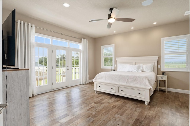 bedroom featuring access to exterior, ceiling fan, and light hardwood / wood-style flooring