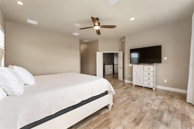 bedroom with light hardwood / wood-style floors and ceiling fan