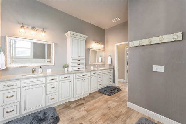 bathroom with vanity and hardwood / wood-style floors