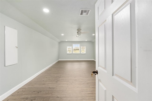 bonus room with wood-type flooring and ceiling fan