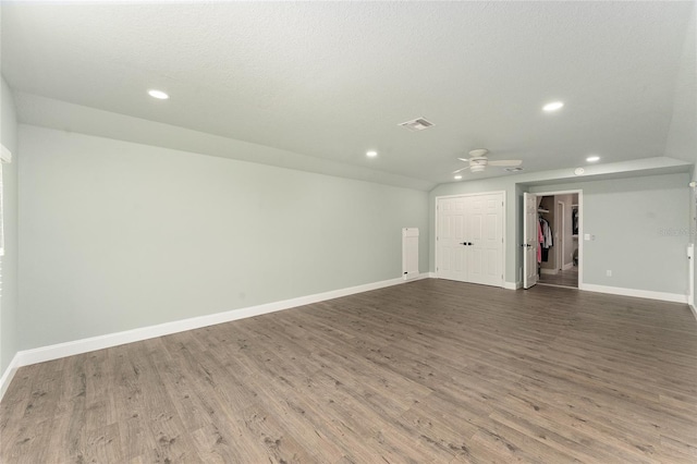 empty room featuring ceiling fan, wood-type flooring, and a textured ceiling