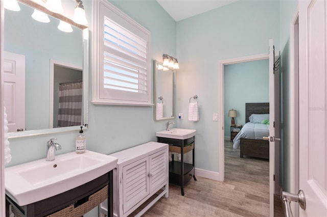 bathroom with curtained shower, vanity, and wood-type flooring