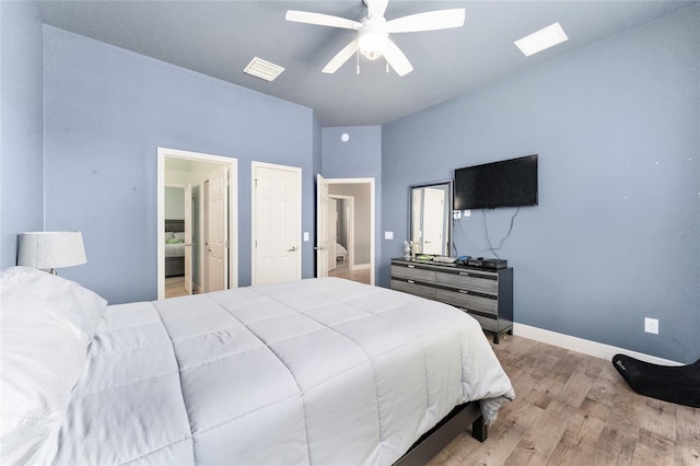 bedroom with light hardwood / wood-style floors, vaulted ceiling, and ceiling fan