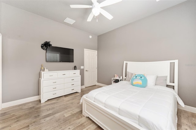 bedroom with lofted ceiling, light hardwood / wood-style flooring, and ceiling fan