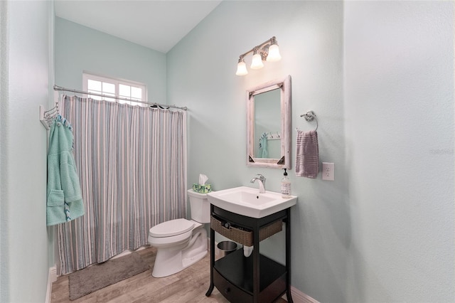 bathroom featuring a shower with curtain, hardwood / wood-style floors, vanity, and toilet