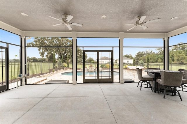 sunroom featuring ceiling fan