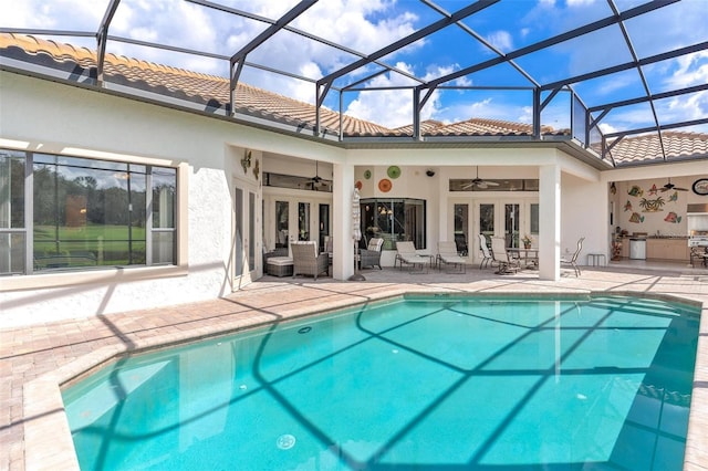 view of pool with a lanai, a patio, and ceiling fan