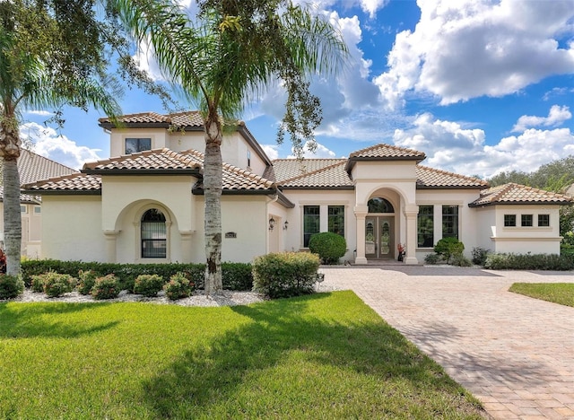 mediterranean / spanish-style house featuring a front lawn