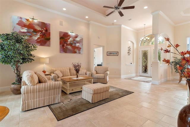 tiled living room with crown molding, a high ceiling, and ceiling fan with notable chandelier