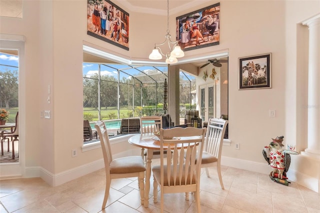 tiled dining area featuring crown molding, ceiling fan, and plenty of natural light