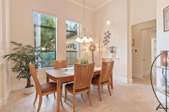 dining area with crown molding and an inviting chandelier