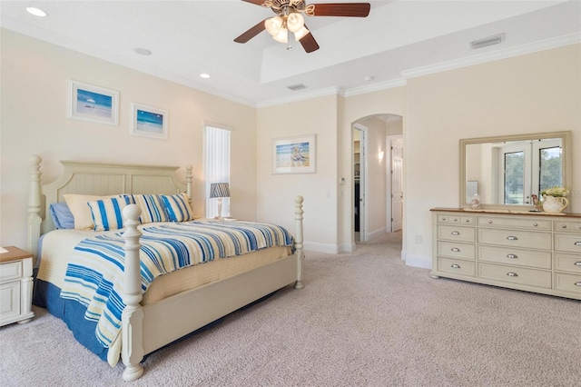 carpeted bedroom with ceiling fan and ornamental molding