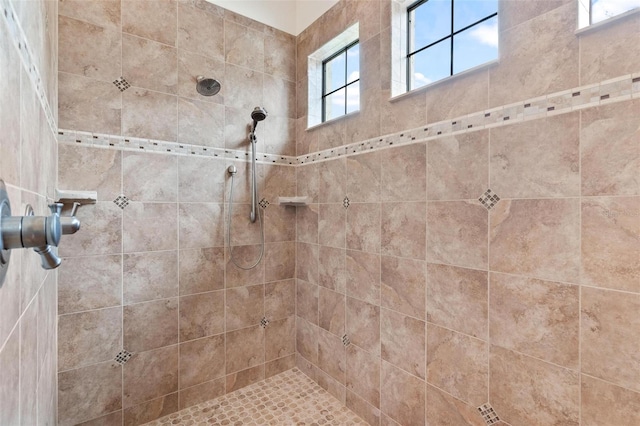 bathroom with a tile shower