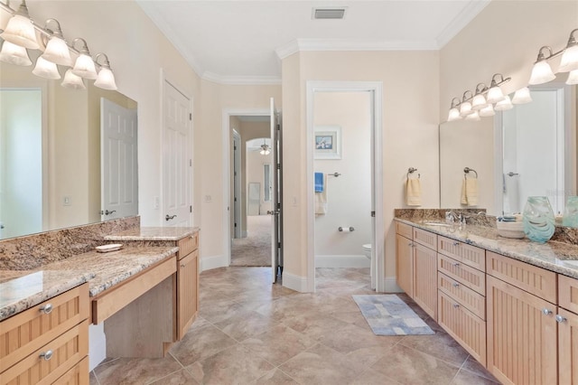 bathroom with toilet, ornamental molding, and vanity