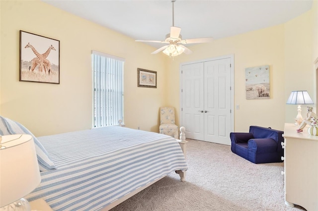 bedroom with a closet, ceiling fan, and carpet flooring