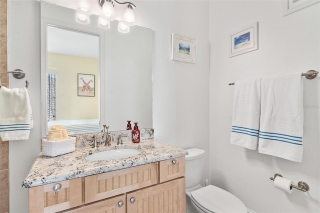 bathroom with vanity and toilet