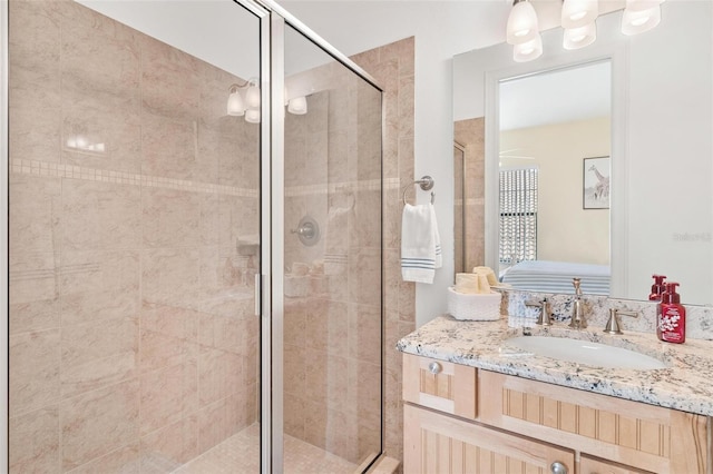 bathroom with vanity and a shower with door