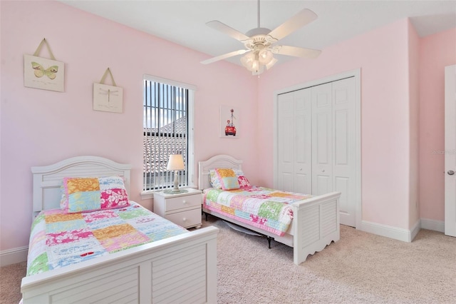 bedroom with light colored carpet, a closet, and ceiling fan