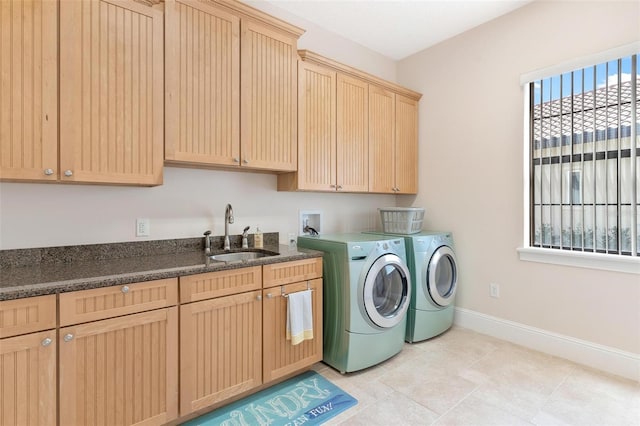 laundry room with cabinets, washer and dryer, sink, and light tile patterned floors